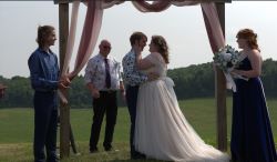 Spencer and Bailey standing at the altar on their wedding day